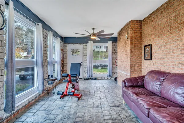 a living room with furniture fireplace and floor to ceiling windows