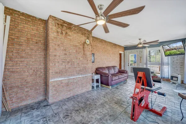 a living room with furniture a flat screen tv and a table