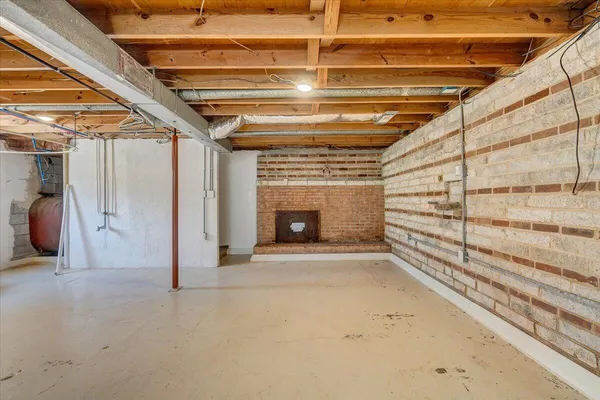 a view of an empty room with a fireplace