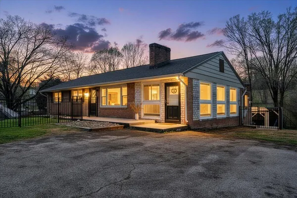 a view of a house with backyard and sitting area