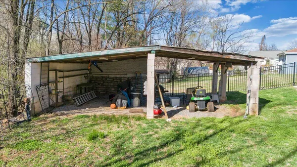 a backyard of a house with table and chairs