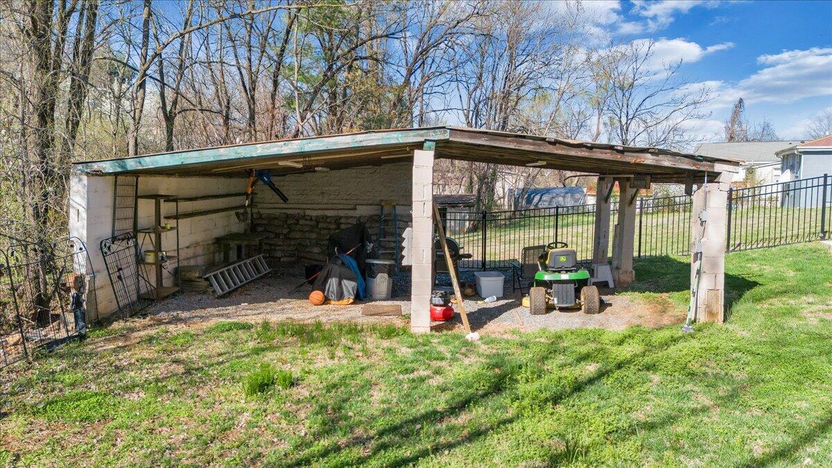 2129 Twelve Oclock Knob Road Salem, VA 24153 - Photo 40 of 48 a view of a patio with a table and chairs under an umbrella
