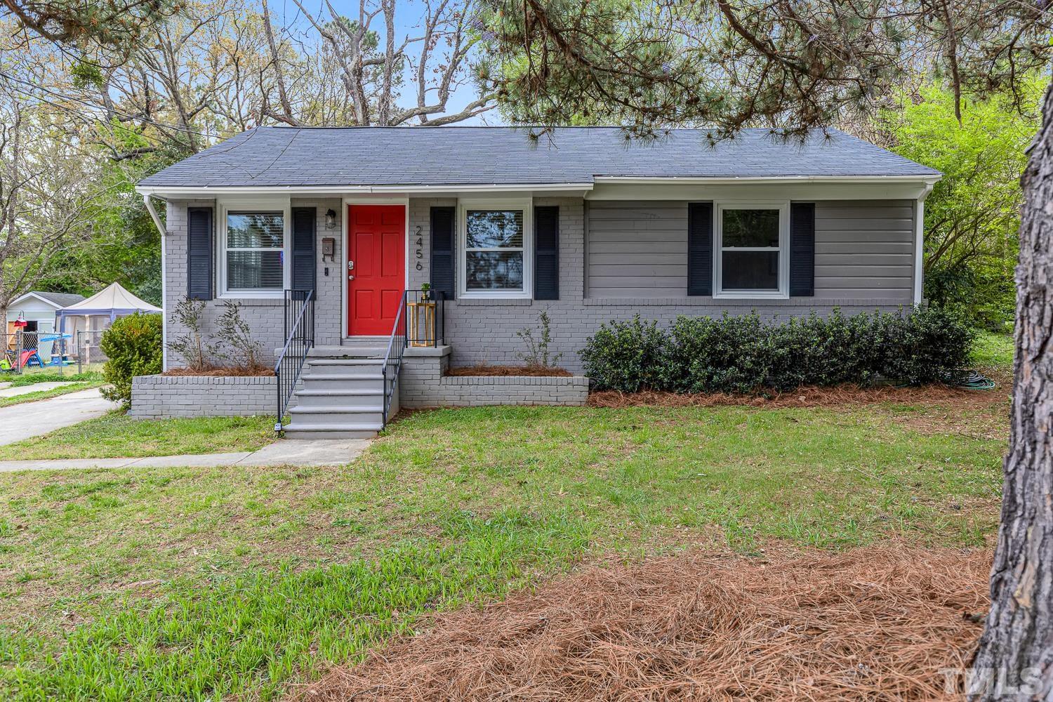 2456 Milburnie Road Raleigh, NC 27610 - Photo 1 of 23 a front view of a house with garden