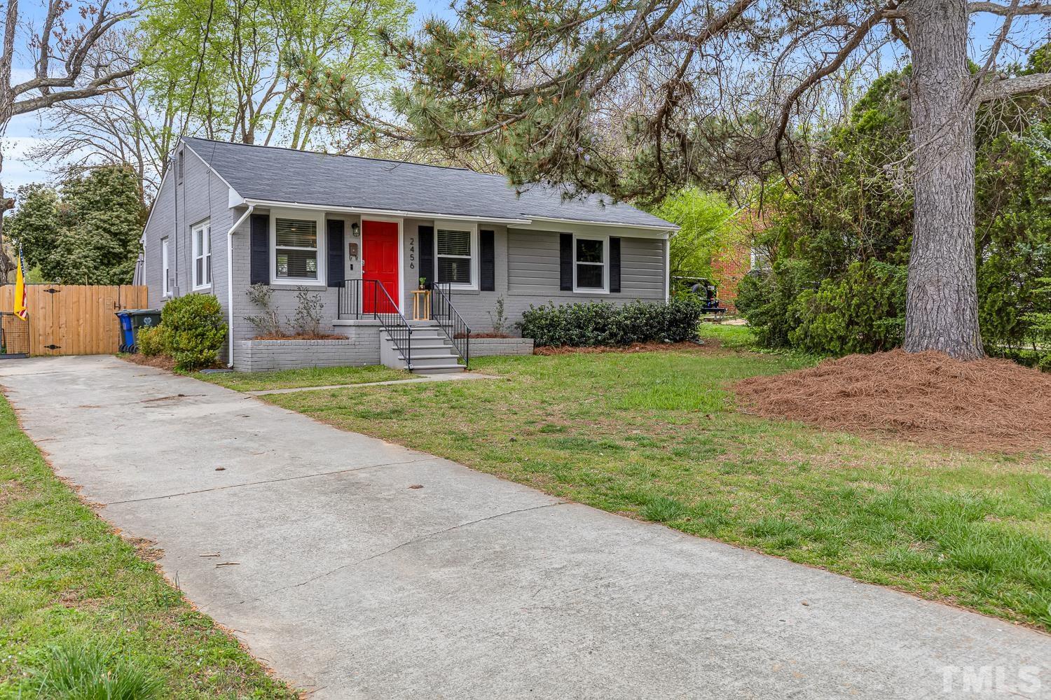 2456 Milburnie Road Raleigh, NC 27610 - Photo 2 of 23 front view of a house and a yard with trees