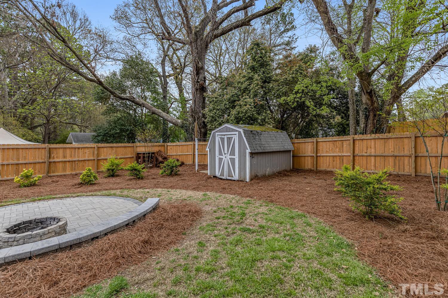 2456 Milburnie Road Raleigh, NC 27610 - Photo 21 of 23 a backyard of a house with a tree and fence