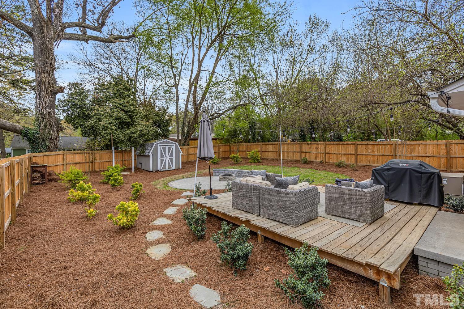 2456 Milburnie Road Raleigh, NC 27610 - Photo 23 of 23 a view of a backyard with sitting area and furniture