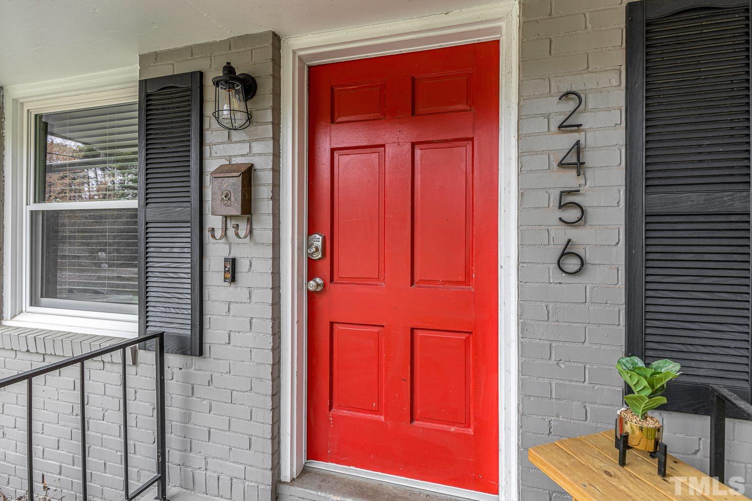 2456 Milburnie Road Raleigh, NC 27610 - Photo 3 of 23 a potted plant in front of a door