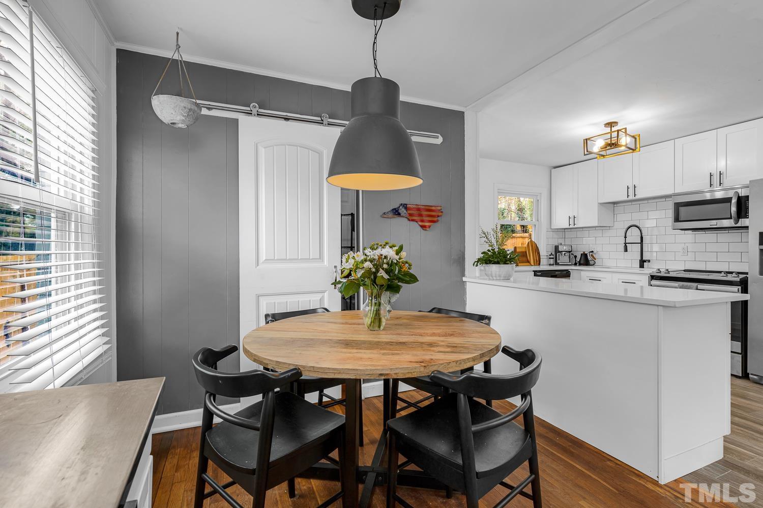 2456 Milburnie Road Raleigh, NC 27610 - Photo 6 of 23 a dining room filled chandelier and wooden floor