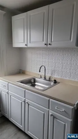 a kitchen with a stove a sink and a refrigerator