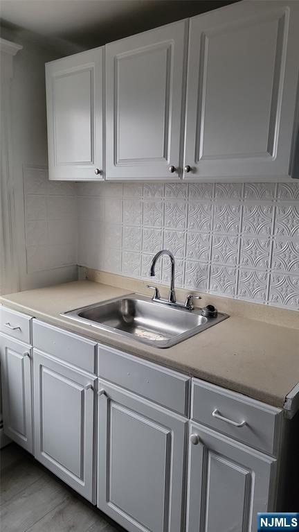 165 Main Street, Unit SECOND Garfield, NJ 07026 - Photo 4 of 12 a kitchen with white cabinets and a sink