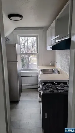 a stove top oven sitting inside of a kitchen
