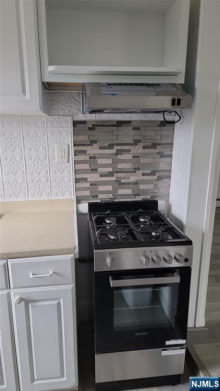 165 Main Street, Unit SECOND Garfield, NJ 07026 - Photo 6 of 12 a stove top oven sitting inside of a kitchen