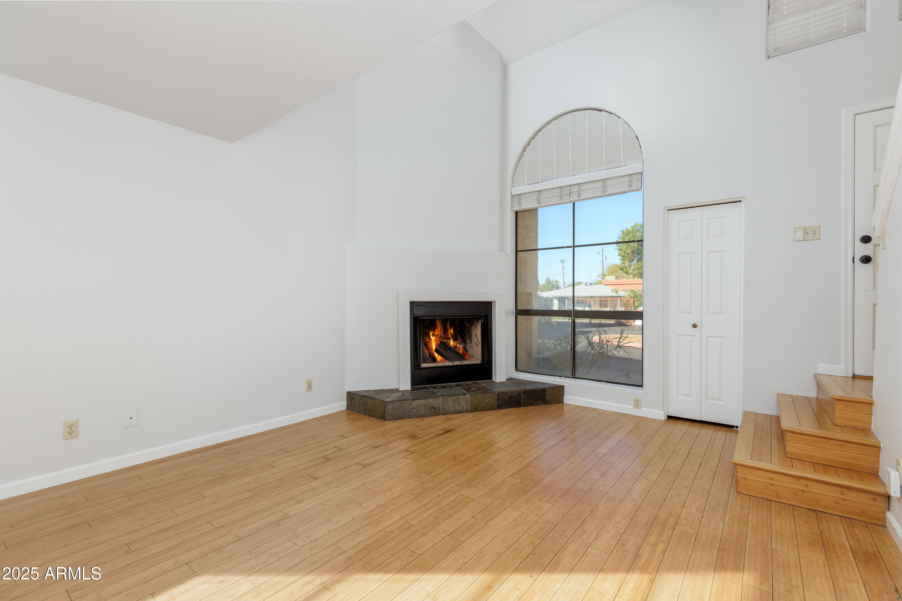 1025 East Highland Avenue, Unit 30 Phoenix, AZ 85014 - Photo 7 of 20 a view of an empty room with wooden floor and a window