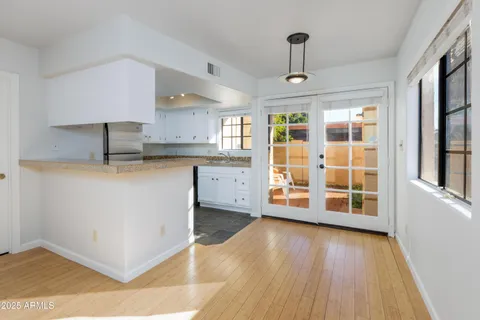 a kitchen with stainless steel appliances granite countertop a stove and a wooden floors