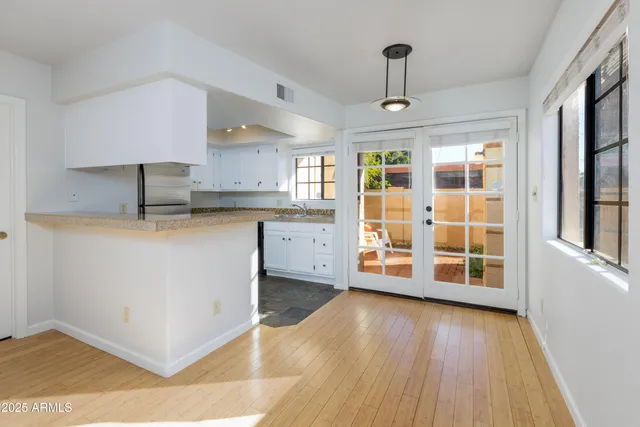 a kitchen with stainless steel appliances granite countertop a stove and a wooden floors