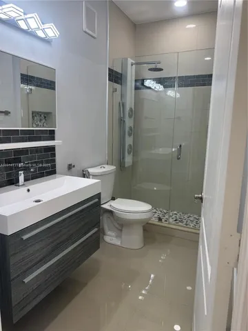 a white refrigerator freezer and a stove sitting inside of a kitchen