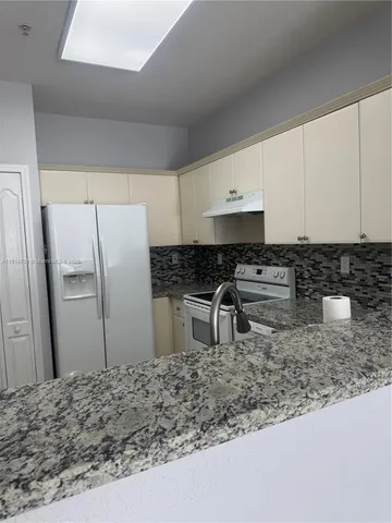 a white refrigerator freezer sitting in a kitchen