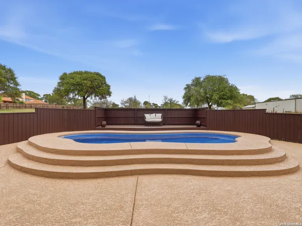 a view of a porch with table and chairs