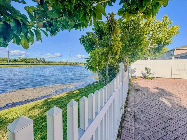 a view of a yard with an tree and a fence