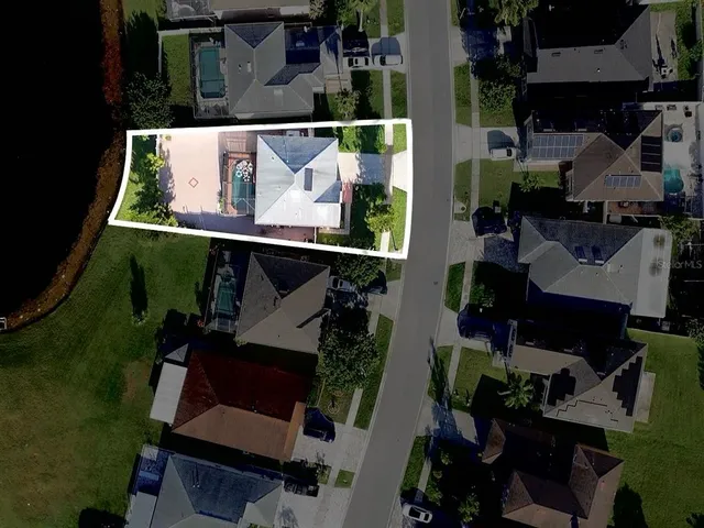 an aerial view of a house with a yard