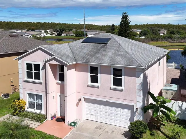 a aerial view of a house with a yard