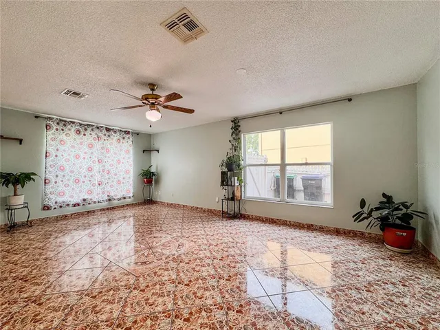 a view of a livingroom with a ceiling fan and window