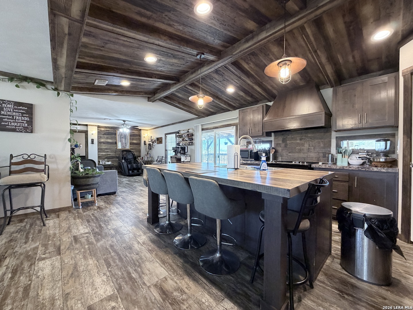 152 County Roads 2667 Devine, TX 78016 - Photo 21 of 51 a kitchen with lots of wooden furniture a table and chairs