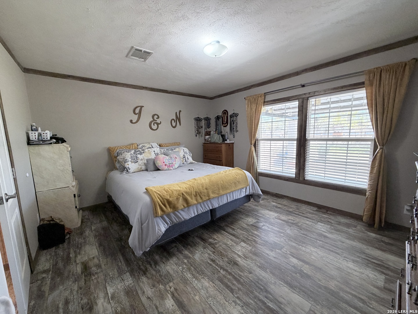 152 County Roads 2667 Devine, TX 78016 - Photo 30 of 51 a bedroom with a bed a mirror and a window