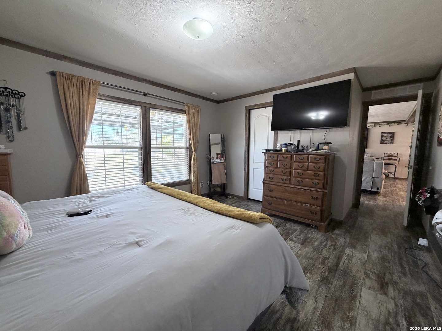 152 County Roads 2667 Devine, TX 78016 - Photo 31 of 51 a bedroom with a bed and a large window