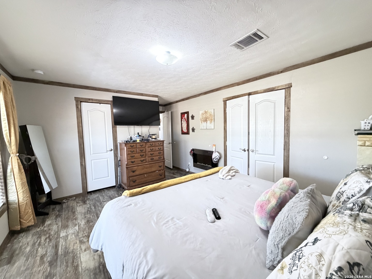 152 County Roads 2667 Devine, TX 78016 - Photo 37 of 51 a bed room with a bed and a flat screen tv