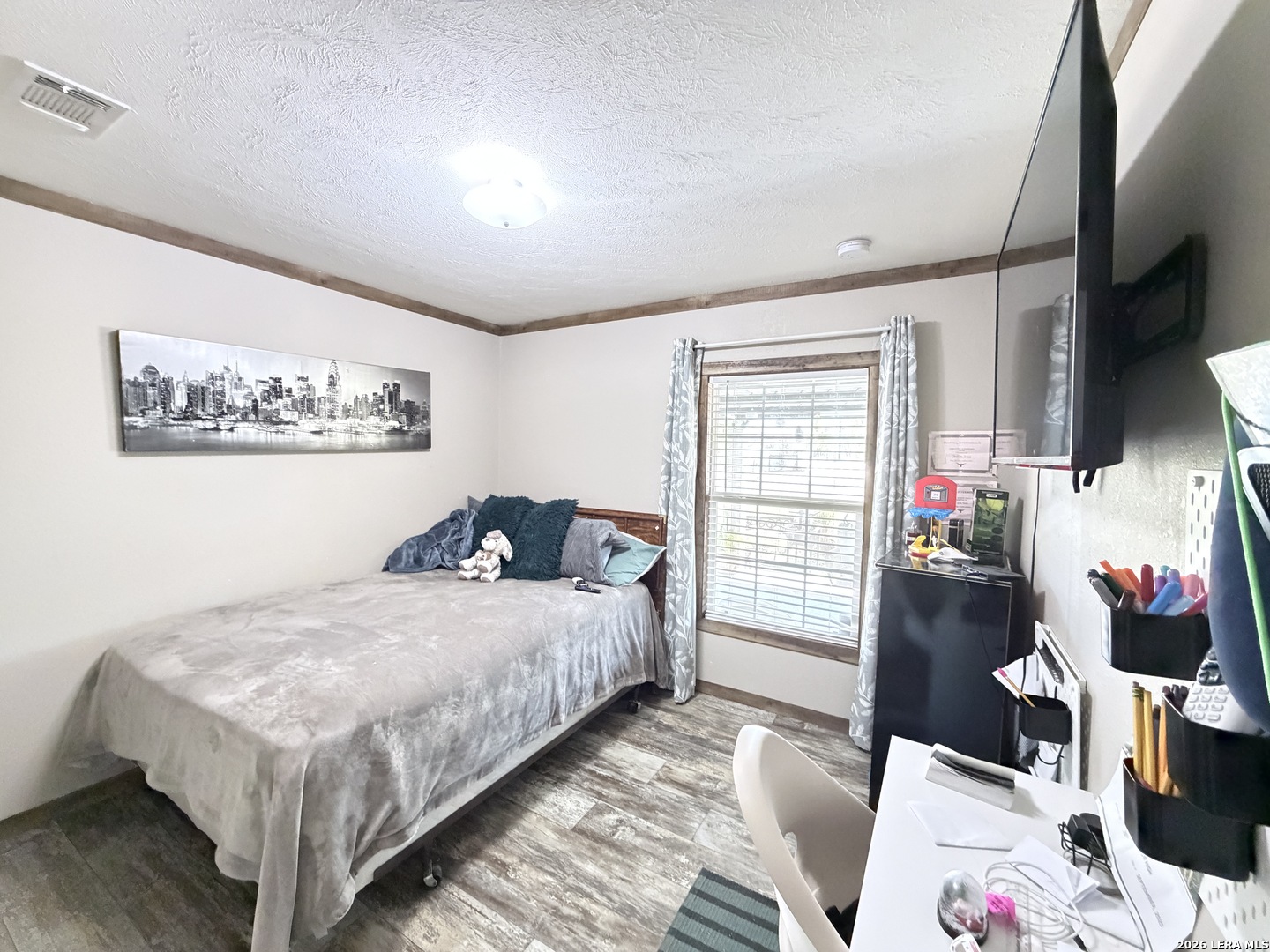 152 County Roads 2667 Devine, TX 78016 - Photo 38 of 51 a bedroom with a bed and wooden floor