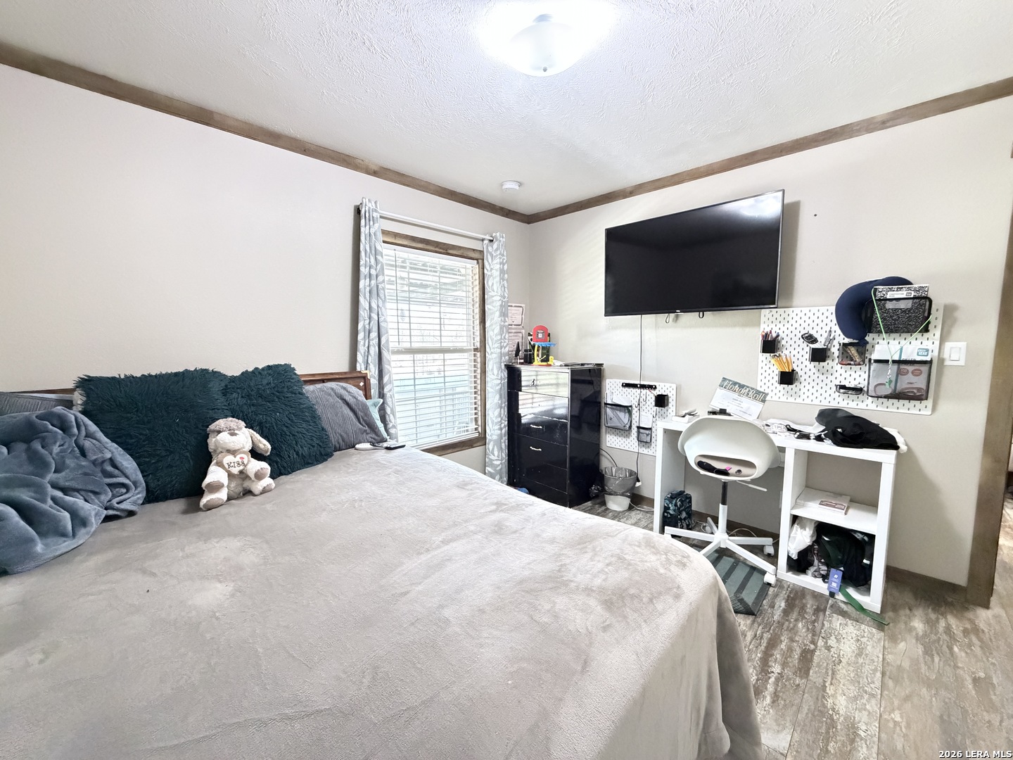152 County Roads 2667 Devine, TX 78016 - Photo 39 of 51 a bedroom with a bed and a flat screen tv