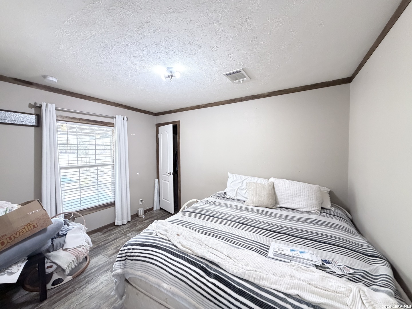 152 County Roads 2667 Devine, TX 78016 - Photo 41 of 51 a bedroom with a large bed and a window