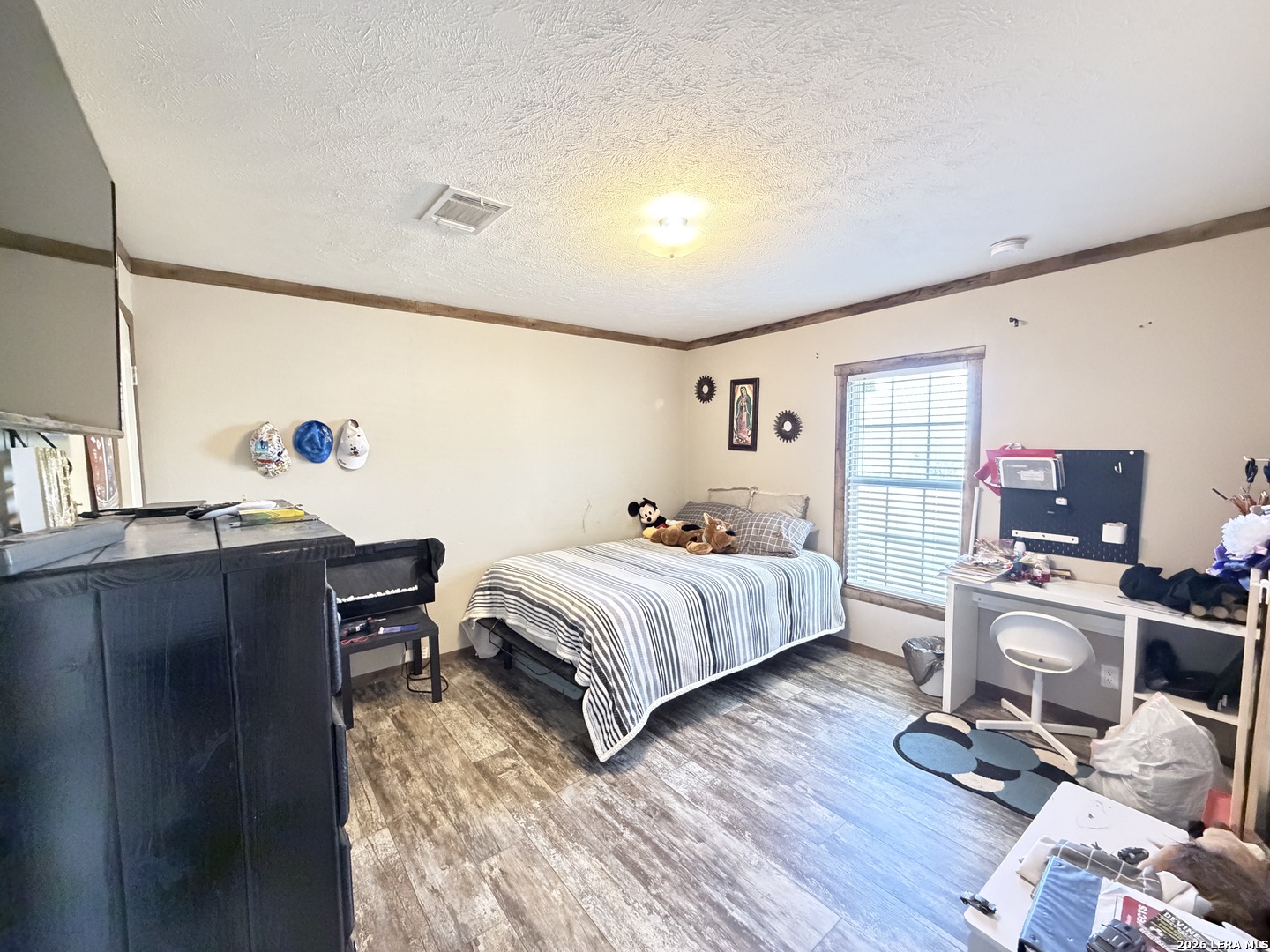 152 County Roads 2667 Devine, TX 78016 - Photo 43 of 51 a bedroom with a bed and a desk