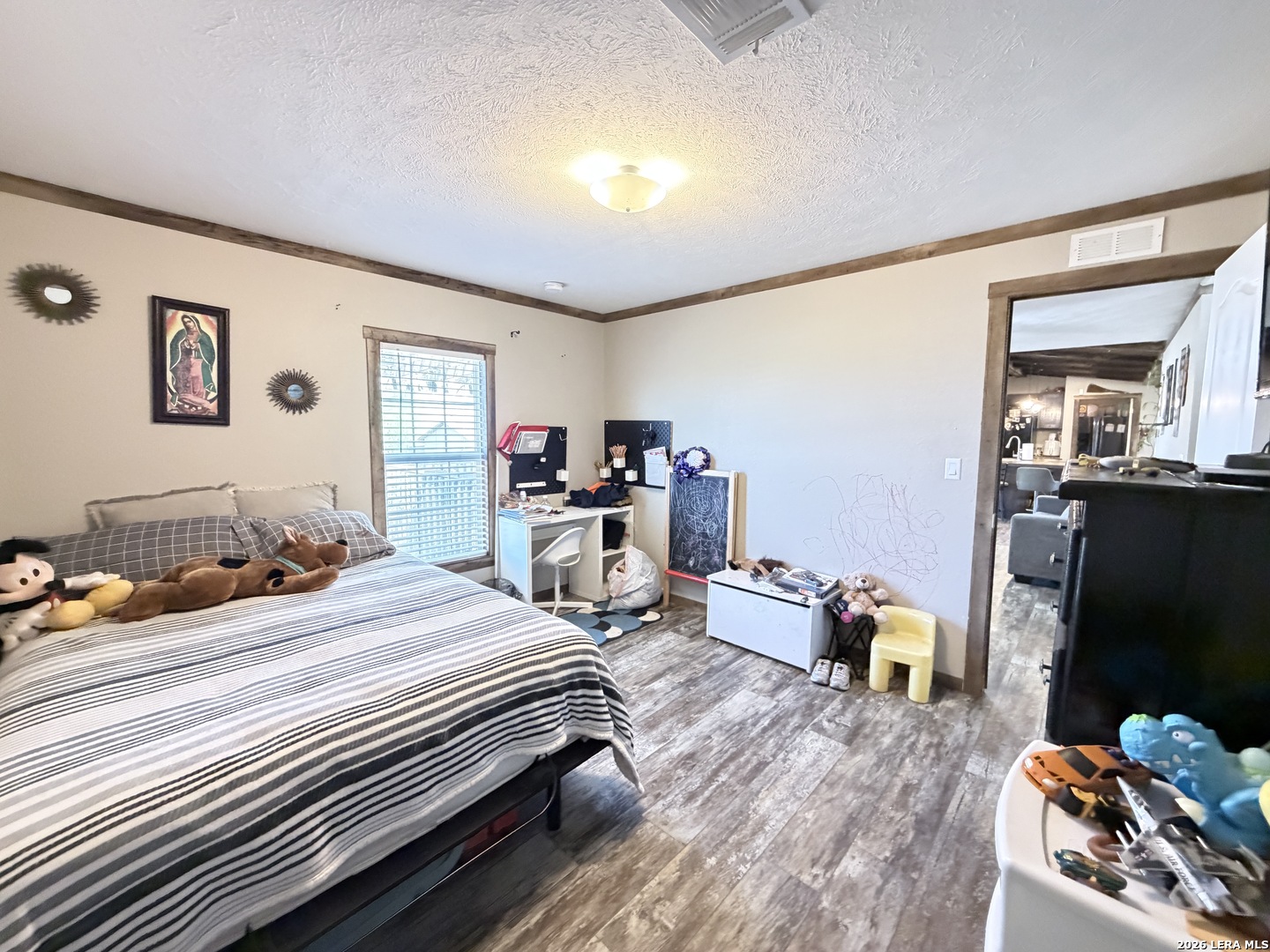 152 County Roads 2667 Devine, TX 78016 - Photo 44 of 51 a bedroom with a bed and wooden floor