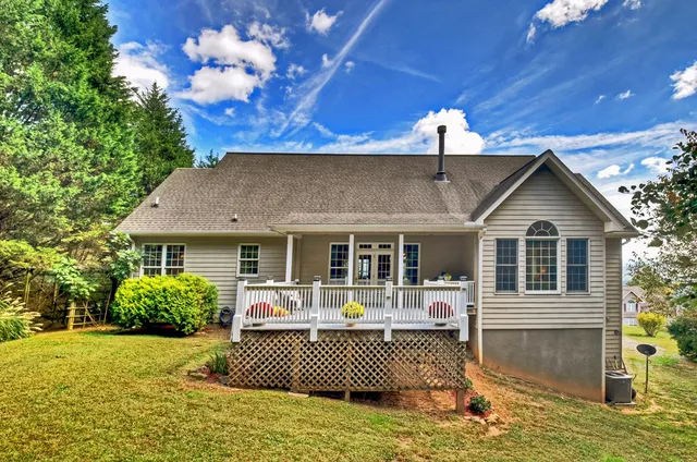 a view of roof deck with wooden floor and seating space