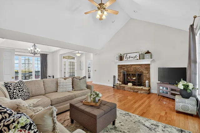 a kitchen with stainless steel appliances granite countertop a sink a stove a refrigerator cabinets and dining table