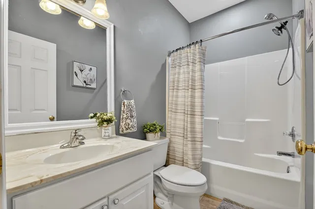 a white bath tub sitting next to a white sink