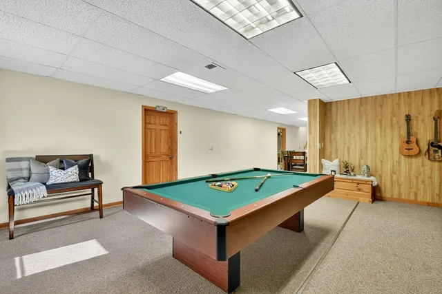 a kitchen with stainless steel appliances a stove a sink cabinets and a dining table