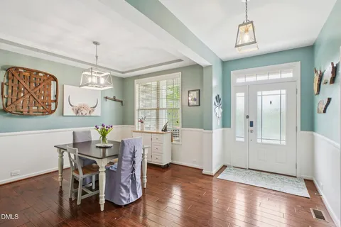 a view of a dining room with furniture window and wooden floor