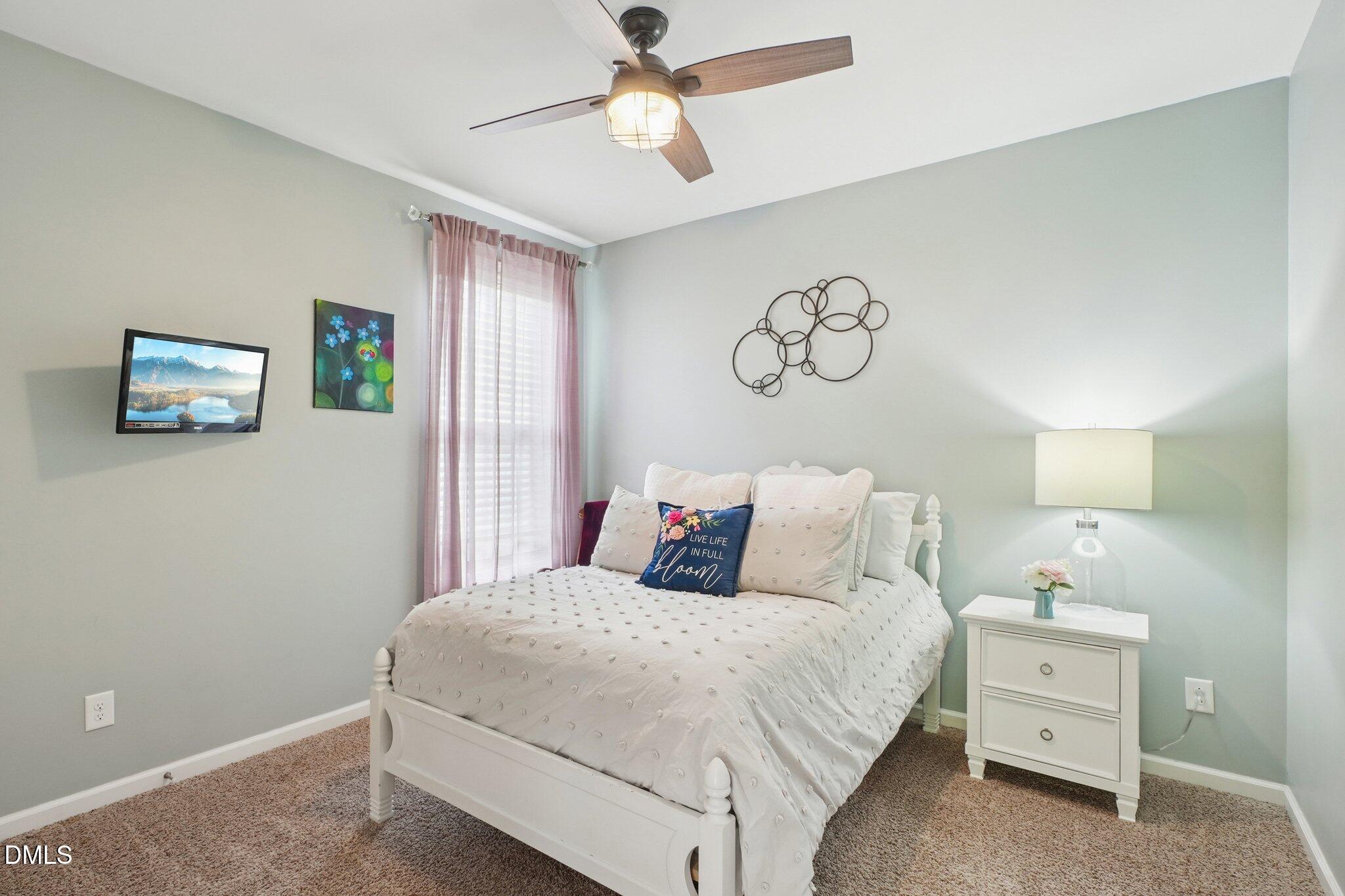 203 Hico Way Durham, NC 27703 - Photo 24 of 62 a bedroom with a bed and a chandelier