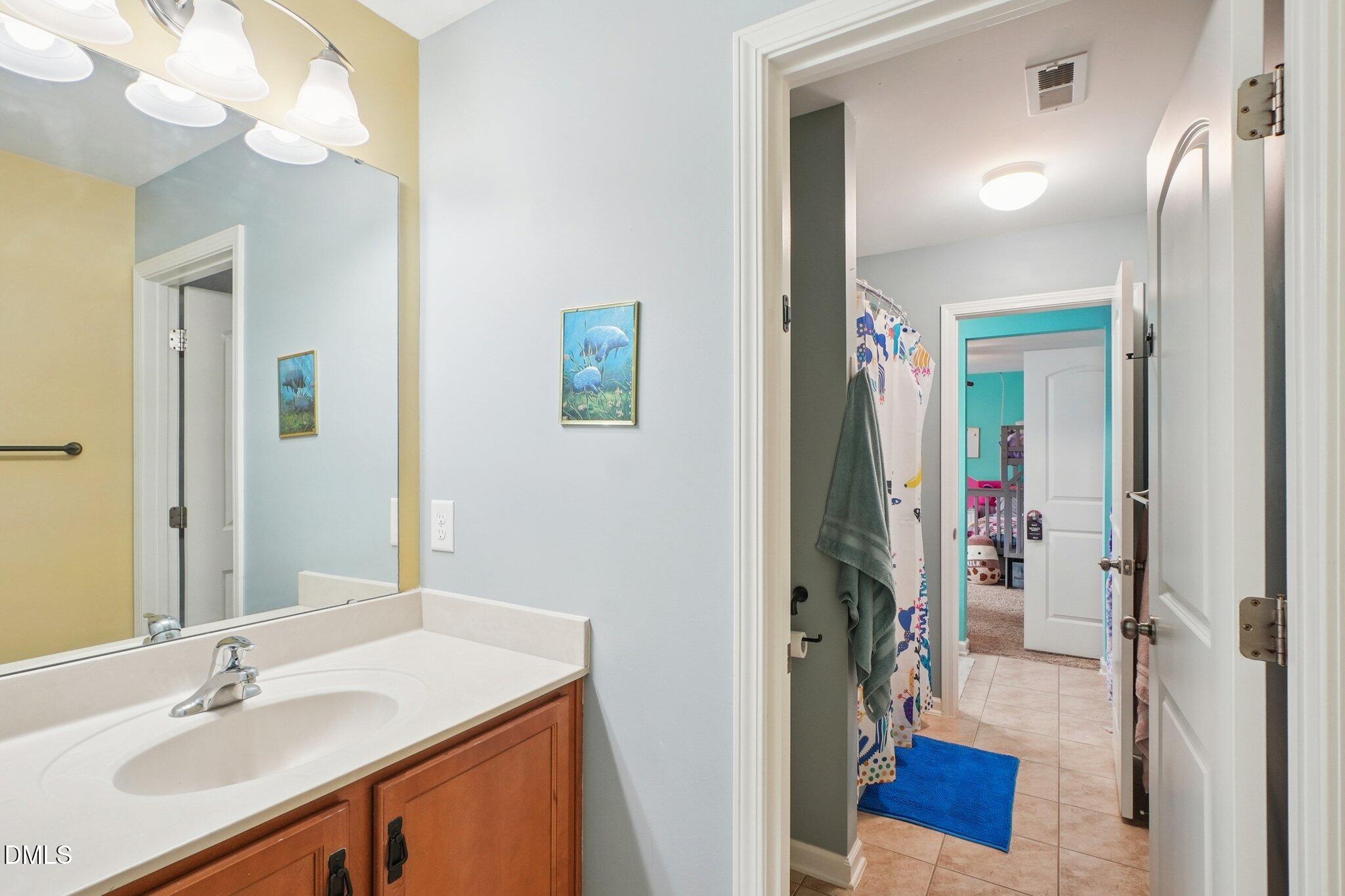 203 Hico Way Durham, NC 27703 - Photo 33 of 62 a bathroom with a sink vanity and a mirror