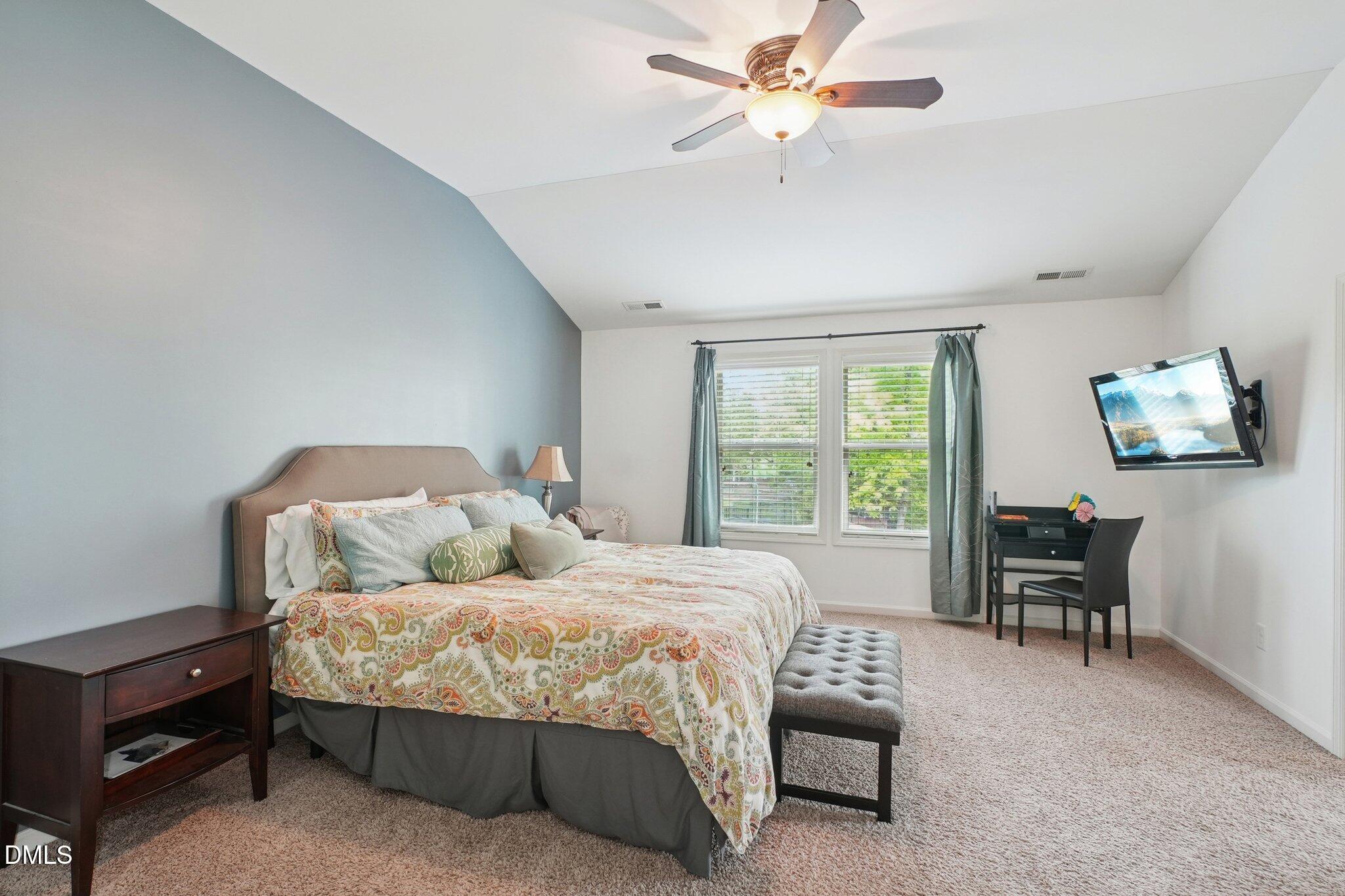 203 Hico Way Durham, NC 27703 - Photo 37 of 62 a bedroom with a bed and a chandelier