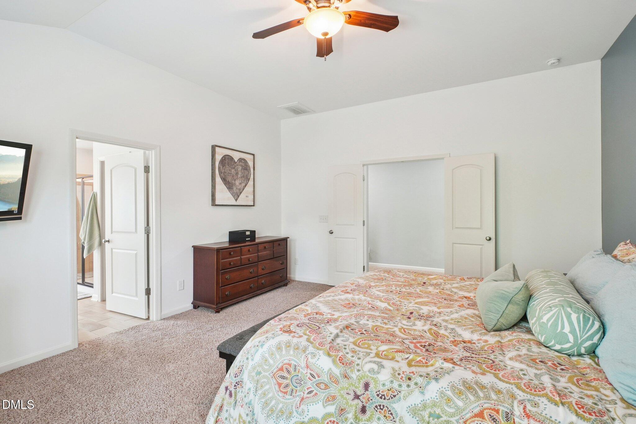 203 Hico Way Durham, NC 27703 - Photo 39 of 62 a bedroom with a bed and a chandelier