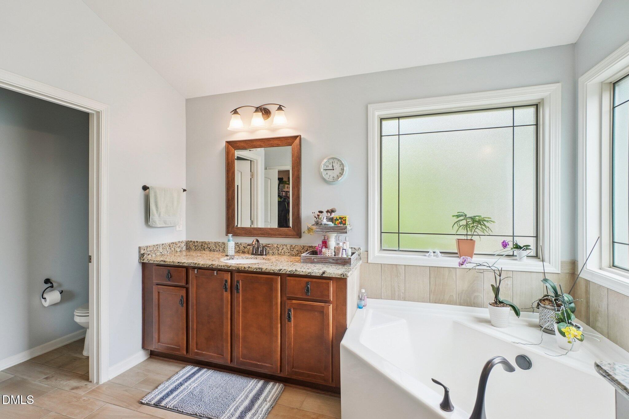 203 Hico Way Durham, NC 27703 - Photo 42 of 62 a en suite bathroom with a granite countertop sink and a mirror