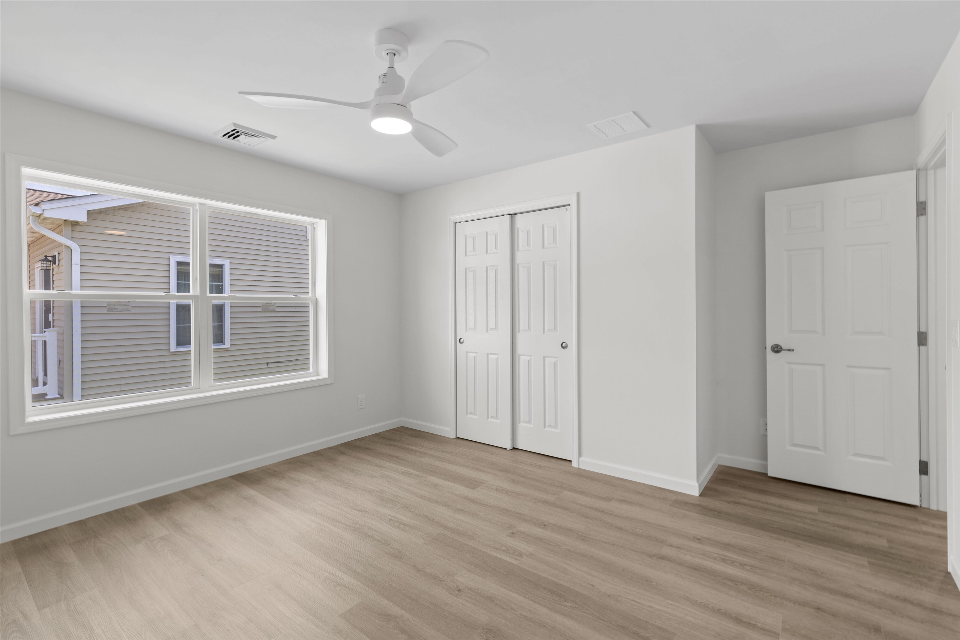 108 Sunray Road Del Haven, NJ 08251 - Photo 11 of 36 a view of an empty room with wooden floor and a window