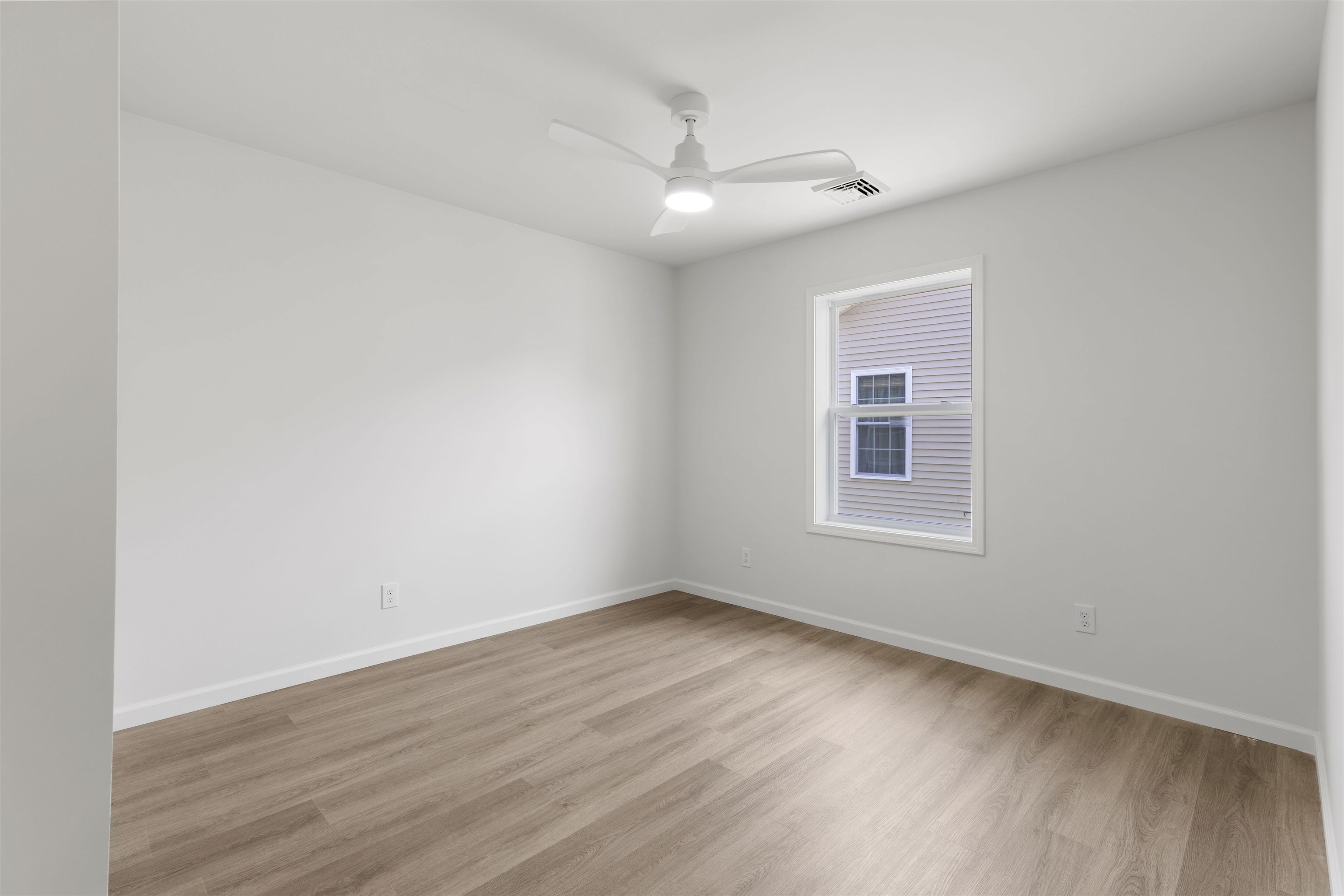 108 Sunray Road Del Haven, NJ 08251 - Photo 16 of 36 an empty room with wooden floor and windows