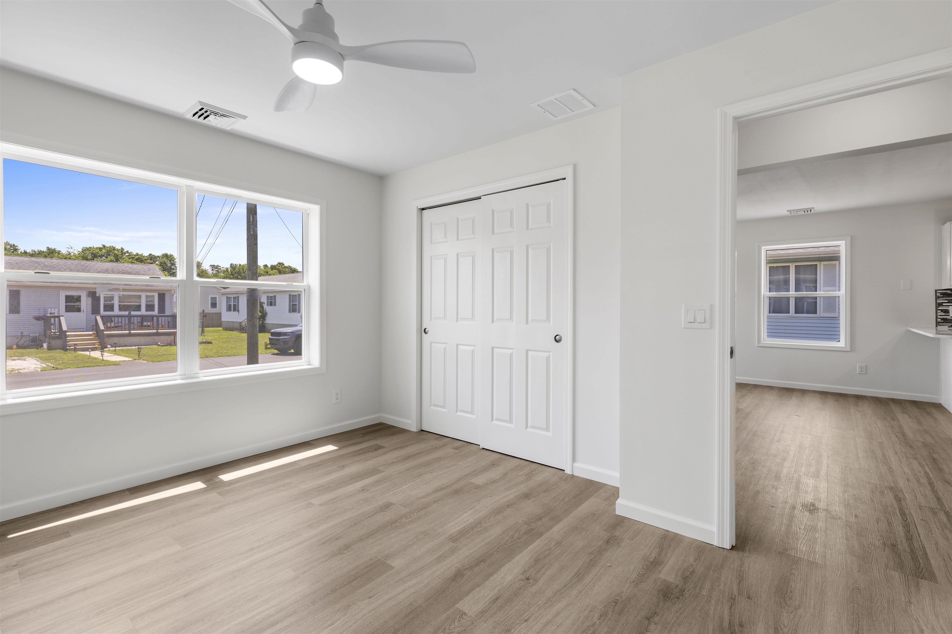 108 Sunray Road Del Haven, NJ 08251 - Photo 17 of 36 an empty room with wooden floor and windows