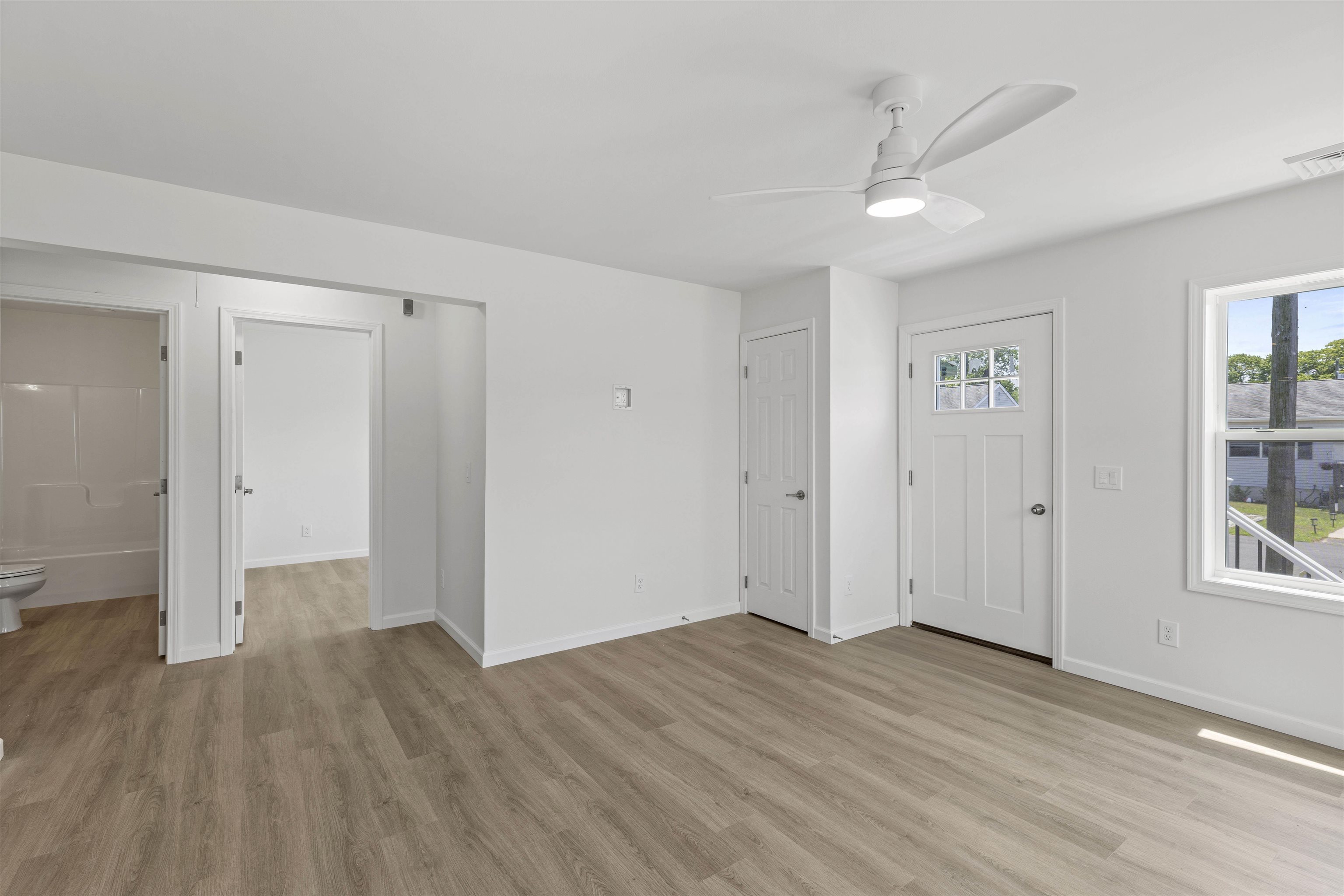 108 Sunray Road Del Haven, NJ 08251 - Photo 19 of 36 an empty room with wooden floor and windows