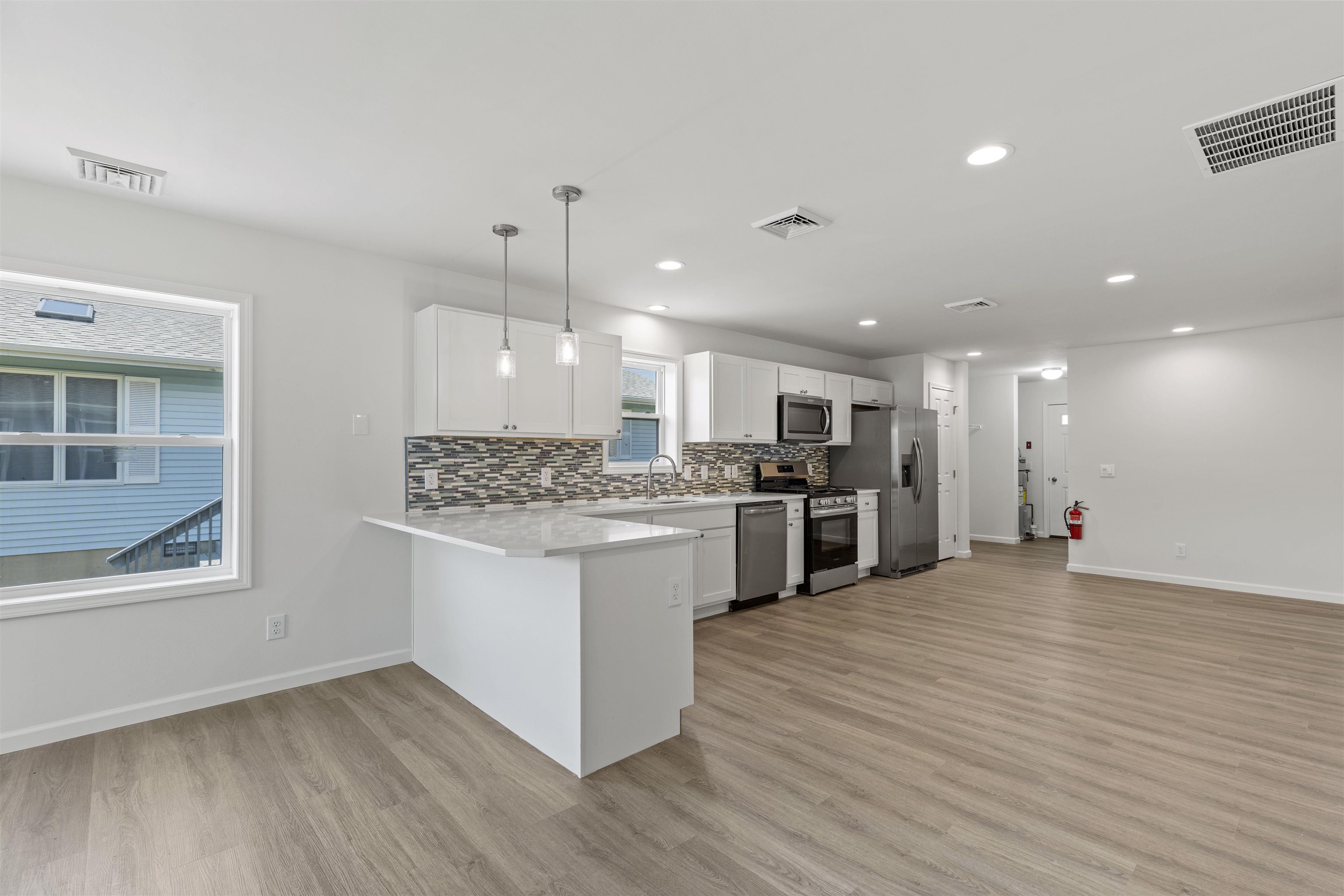 108 Sunray Road Del Haven, NJ 08251 - Photo 5 of 36 a kitchen with stainless steel appliances granite countertop a stove top oven a sink dishwasher and a refrigerator with wooden floor
